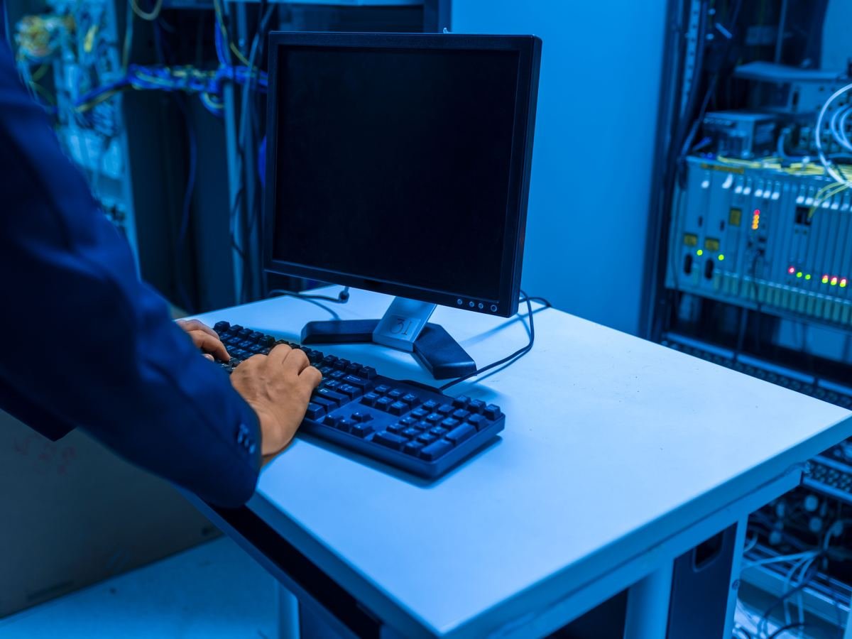 Technician working at a data centre workstation